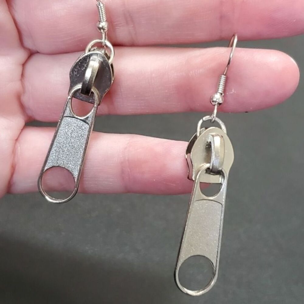 Silver tone dangling zipper earrings